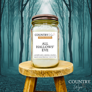 All Hallows' Eve 16oz candle by Country Wyx on a wooden stool with a spooky forest background