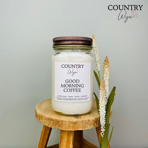 Good Morning Coffee 16oz candle by Country Wyx displayed on a wooden stool with a soft farmhouse-inspired background