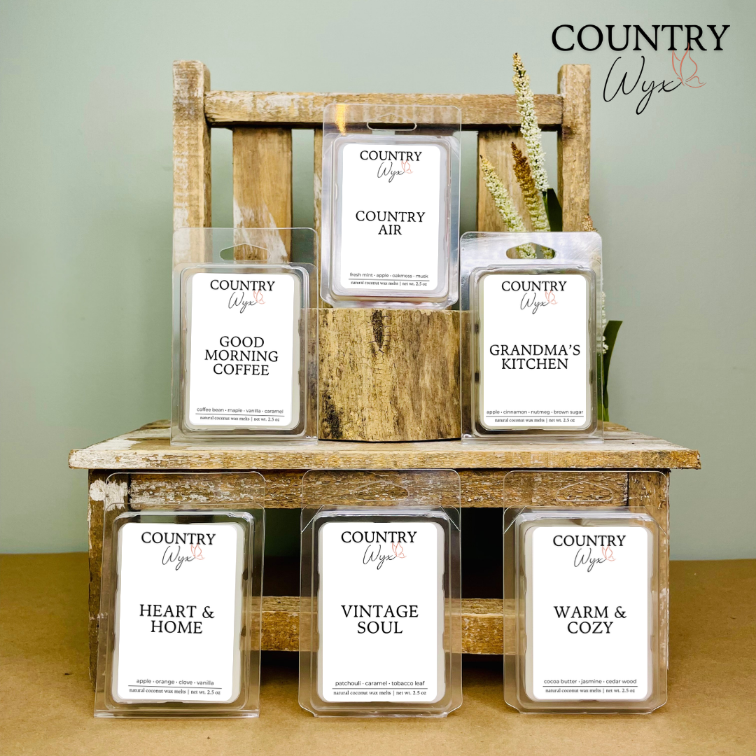 Country Wyx fall wax melt bundle displayed on a rustic wooden shelf with farmhouse-inspired decor, featuring Country Air, Good Morning Coffee, Grandma’s Kitchen, Heart &amp; Home, Vintage Soul, and Warm &amp; Cozy