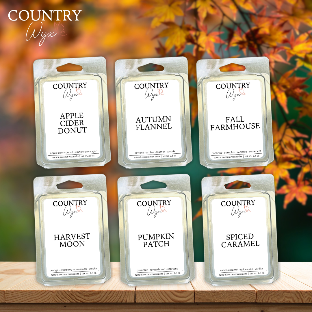 Bundle of  six Country Wyx wax melts with fall-themed names against a blurred autumn leaf background