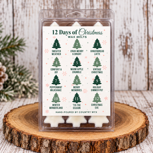 Country Wyx 12 Days of Christmas Wax Melts featuring 12 holiday fragrances in a Christmas tree-shaped wax melt gift set, displayed on a rustic wood slice.