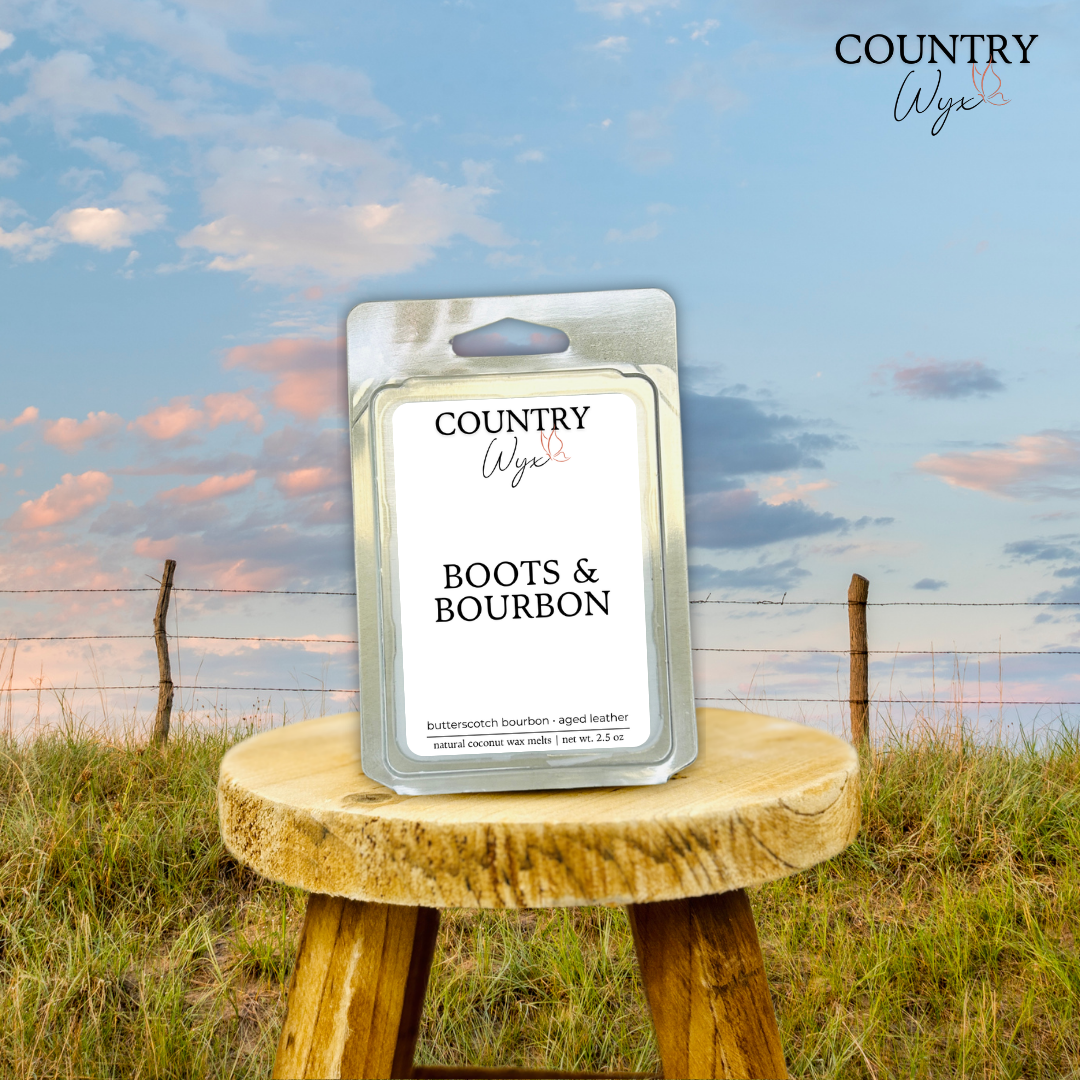 Boots & Bourbon wax melt by Country Wyx on a wooden stool with a Nebraska Sandhills background