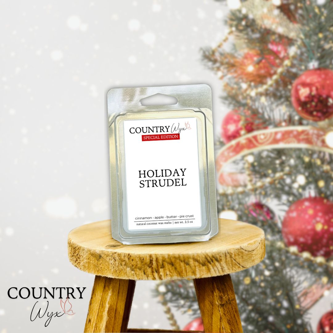 Country Wyx Holiday Strudel wax melt on a wooden stool with a Christmas tree in the background.