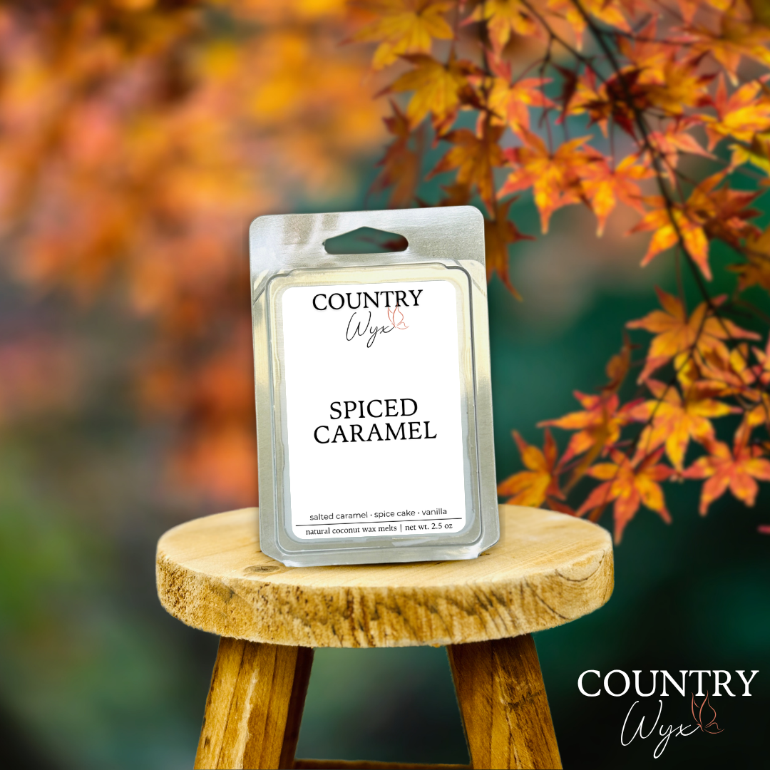 Spiced Caramel wax melt by Country Wyx on a wooden stool with autumn leaves in the background